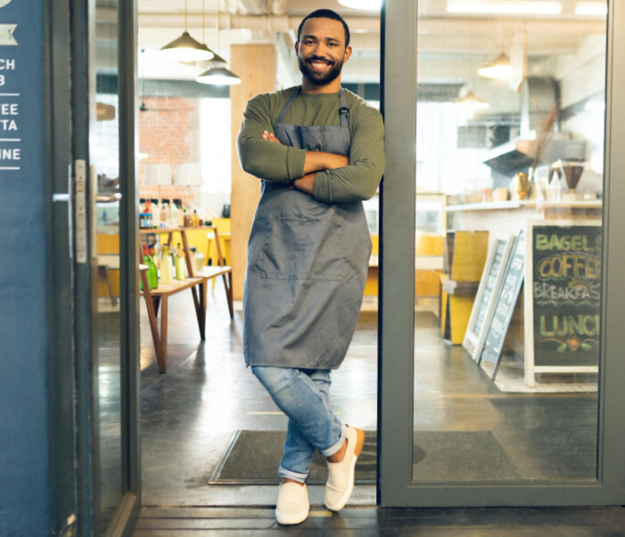 Happy business owner in front of his restaurant